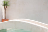 photograph by sheila man of a white minimalistic pool bridge in a private bali pool villa