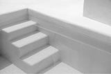 black and white photograph of minimalistic pool stairs in a private bali villa