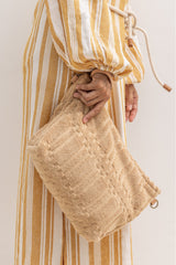 model earing the beige towel fabric bag as a clutch