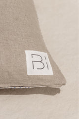 detail of Bi Home Shop logo on beige linen cushion cover